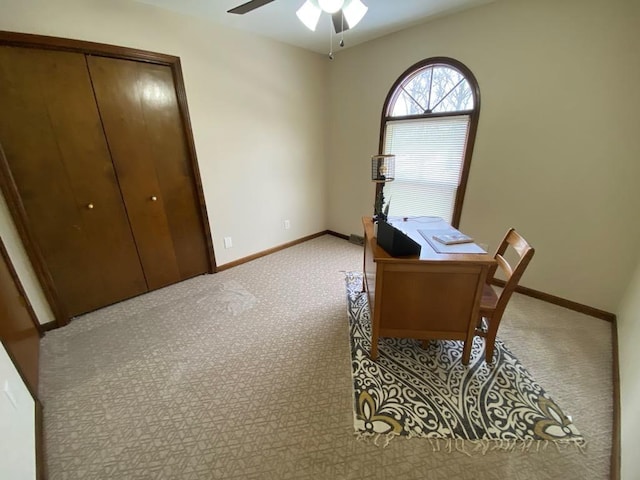 carpeted home office with ceiling fan