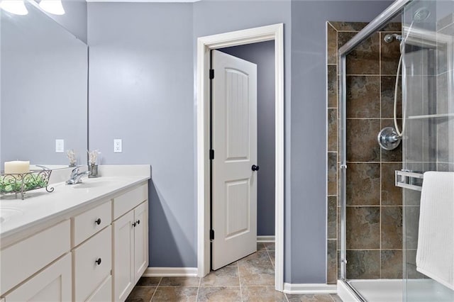 bathroom featuring a shower with door and vanity