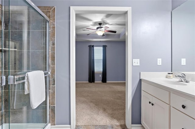 bathroom featuring ceiling fan, walk in shower, and vanity