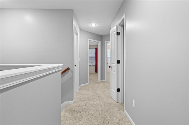 hallway with light colored carpet