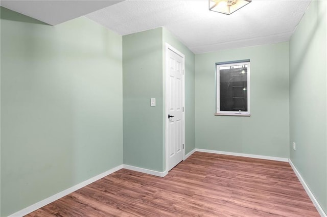 unfurnished room with wood-type flooring