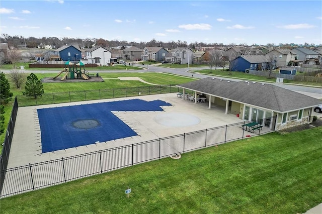 view of swimming pool with a patio, a playground, and a lawn