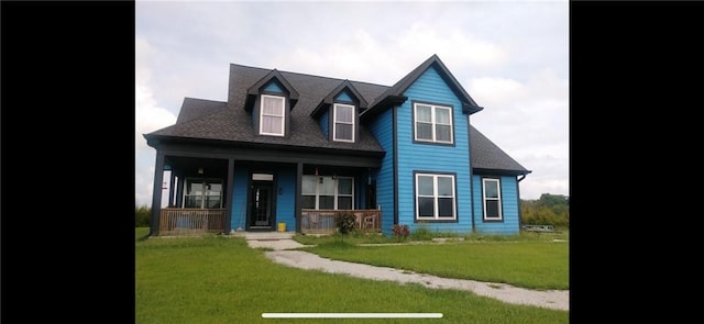 cape cod house with covered porch and a front yard