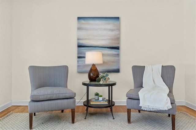 sitting room featuring baseboards and wood finished floors