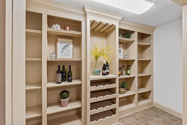 wine area featuring tile patterned flooring and baseboards