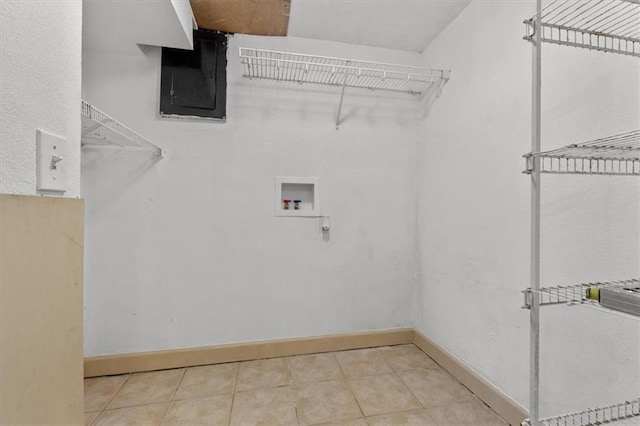 washroom with hookup for a washing machine, laundry area, baseboards, electric panel, and tile patterned floors