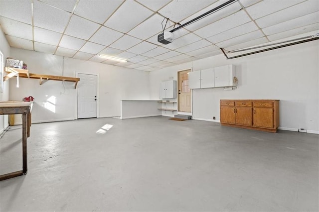 garage with baseboards and a garage door opener