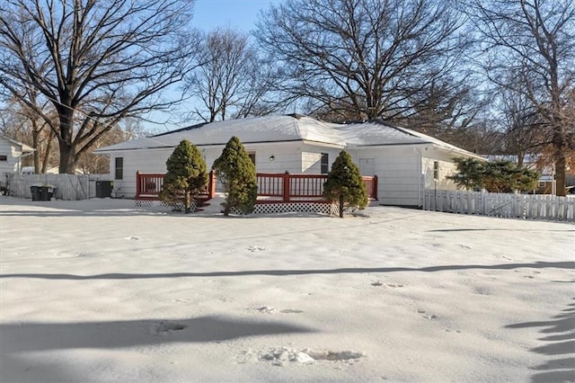 view of front facade with fence and a deck