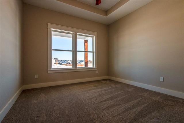 unfurnished room with ceiling fan and carpet