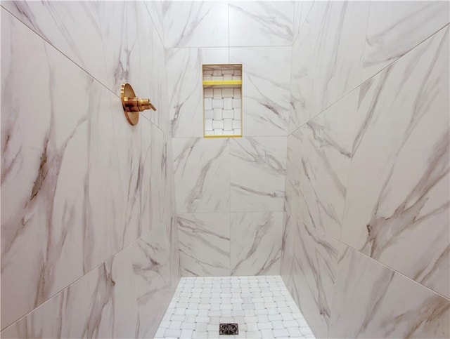 bathroom with a tile shower