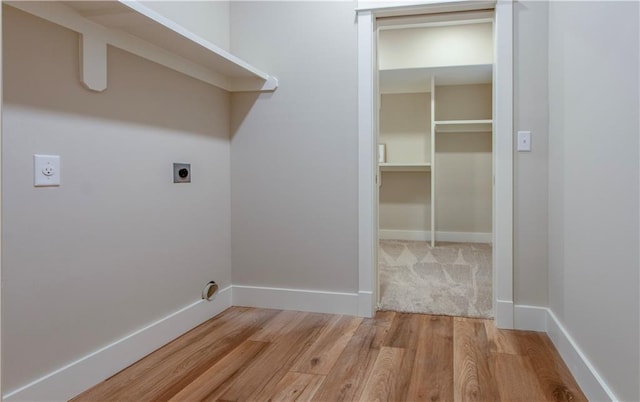 laundry room with hardwood / wood-style floors and hookup for an electric dryer