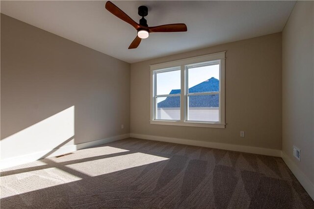 spare room featuring carpet floors and ceiling fan