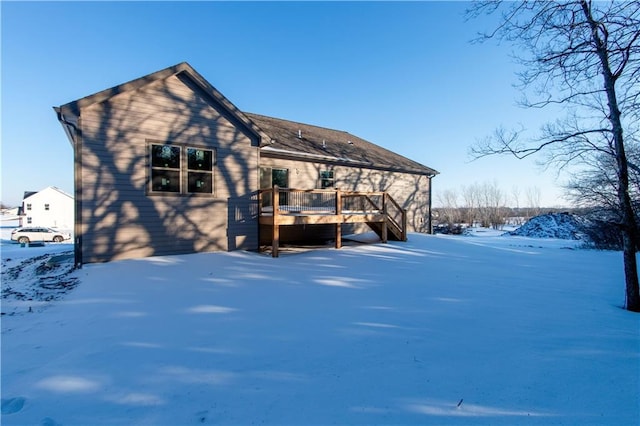 snow covered property featuring a deck