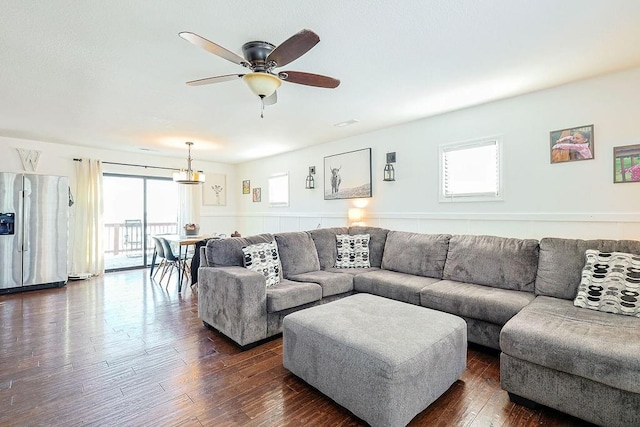 living room with ceiling fan, a healthy amount of sunlight, and dark hardwood / wood-style floors