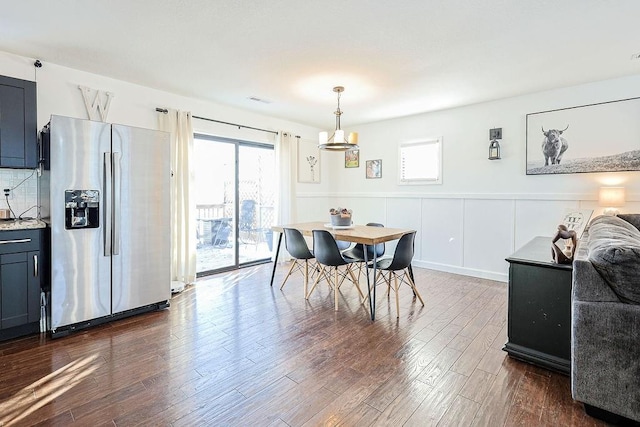 dining area featuring dark wood-type flooring and a wealth of natural light