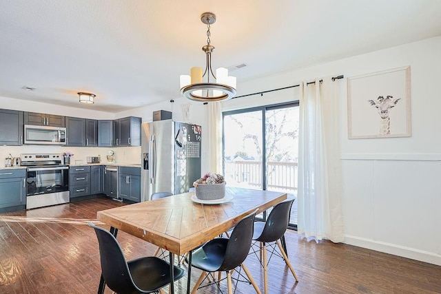 dining space featuring a chandelier and dark hardwood / wood-style floors