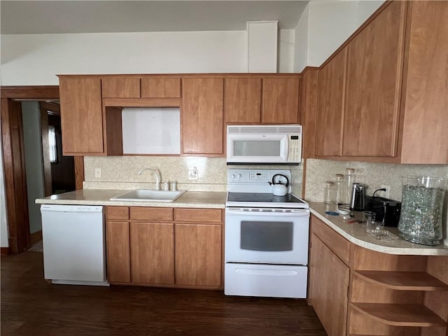 kitchen featuring decorative backsplash, dark hardwood / wood-style flooring, white appliances, and sink