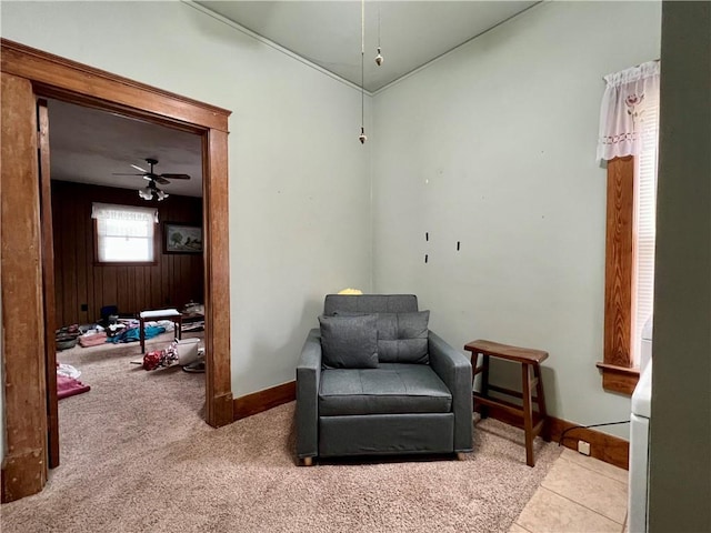 living area with ceiling fan and light carpet