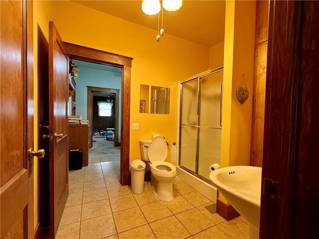 bathroom featuring tile patterned floors and a shower with shower door