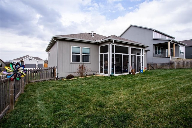 back of property featuring a yard and a sunroom