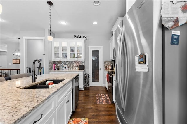 kitchen featuring hanging light fixtures, white cabinetry, appliances with stainless steel finishes, and sink