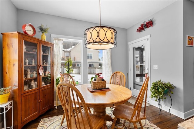 dining space with dark wood-type flooring