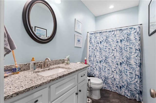 bathroom with vanity, toilet, and walk in shower