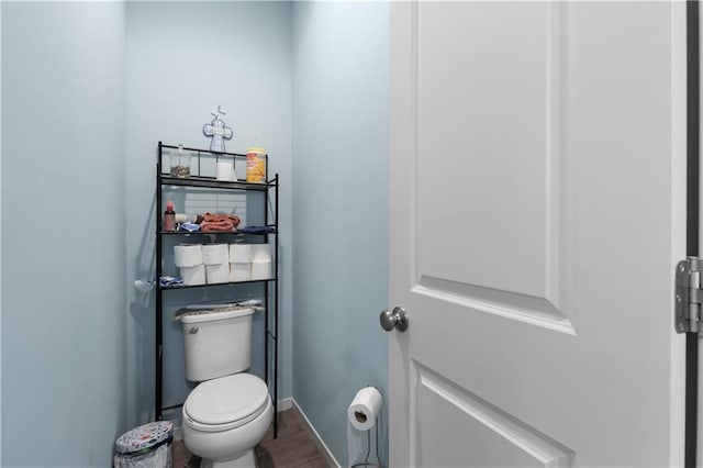 bathroom with hardwood / wood-style floors and toilet