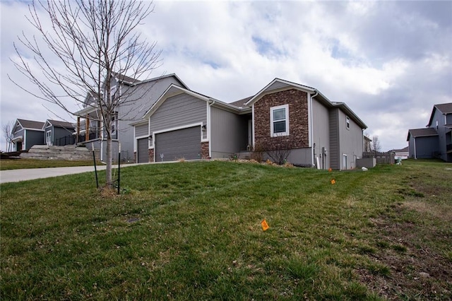 single story home with a garage, stone siding, driveway, and a front lawn