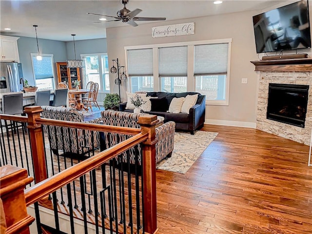25215 W 141st Ter, Olathe, KS 66061 - living area featuring a ceiling fan, healthy amount of natural light, wood finished floors, recessed lighting, and baseboards