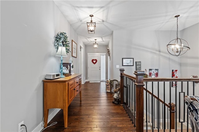 25215 W 141st Ter, Olathe, KS 66061 - hallway featuring a chandelier, dark wood-type flooring, an upstairs landing, and baseboards