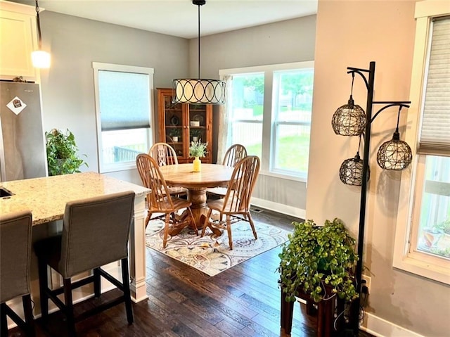 25215 W 141st Ter, Olathe, KS 66061 - dining space featuring dark wood finished floors and baseboards