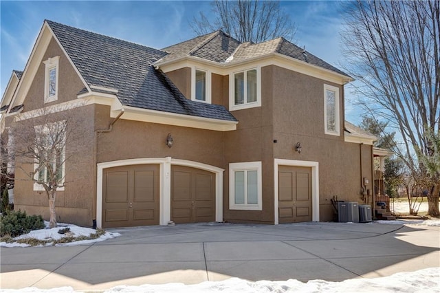 exterior space featuring a garage and central air condition unit