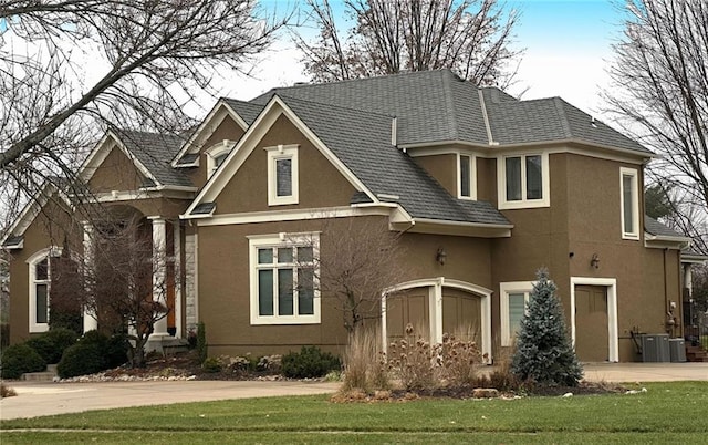 view of front facade with central AC unit and a front lawn