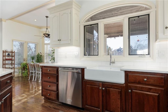 kitchen featuring dark wood-type flooring, sink, tasteful backsplash, stainless steel dishwasher, and ornamental molding