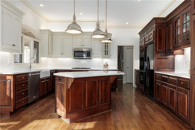 kitchen featuring dark wood-type flooring, dark brown cabinetry, sink, a center island, and black appliances