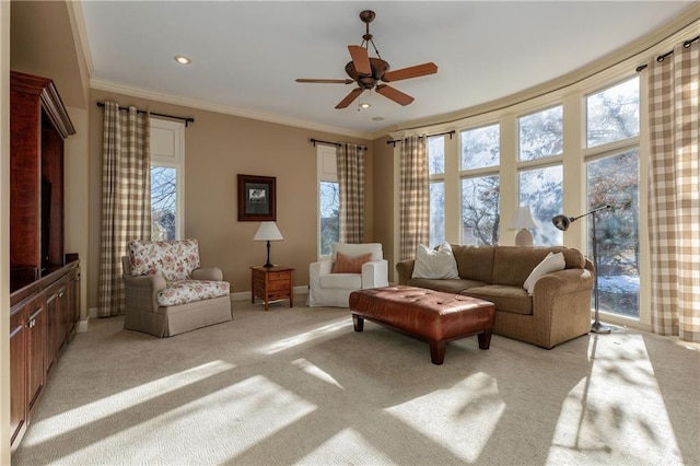 living room with ornamental molding, light colored carpet, and ceiling fan