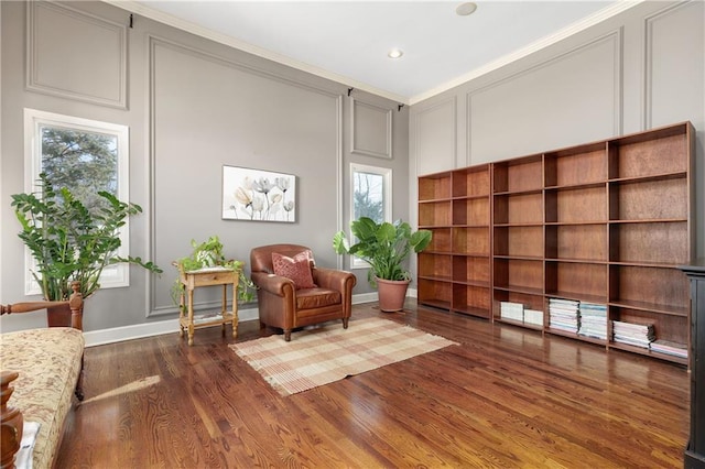 living area with dark wood-type flooring and crown molding