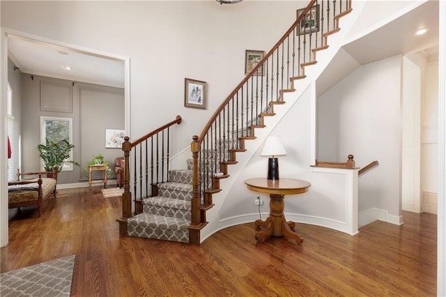 staircase with hardwood / wood-style floors