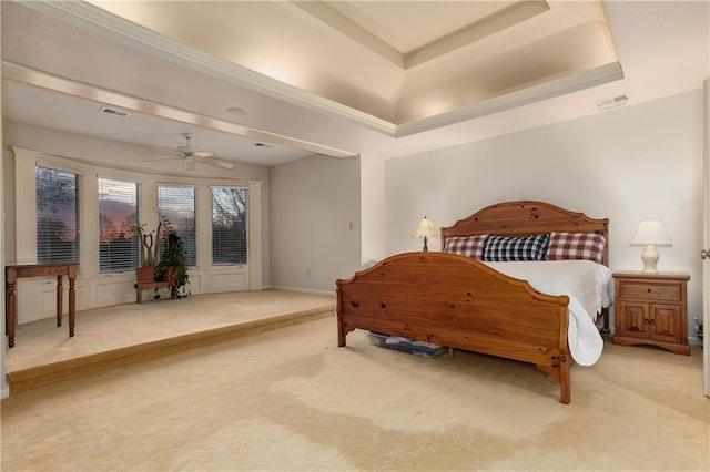 bedroom featuring a tray ceiling, ceiling fan, and carpet