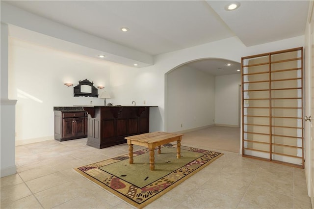 interior space featuring dark brown cabinets and light tile patterned floors