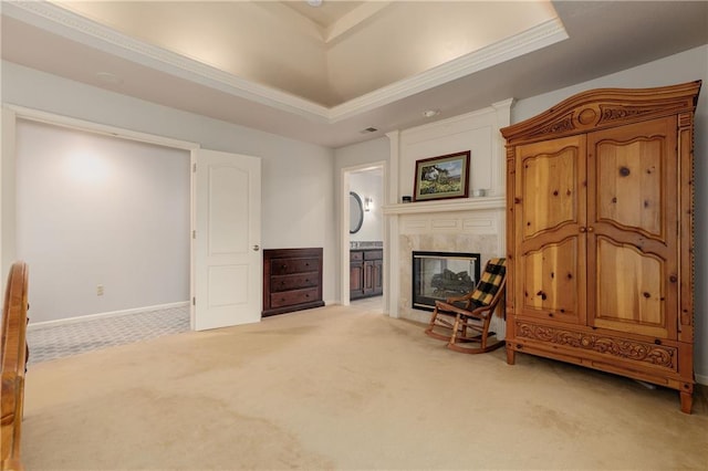 interior space with light colored carpet, a premium fireplace, and a tray ceiling