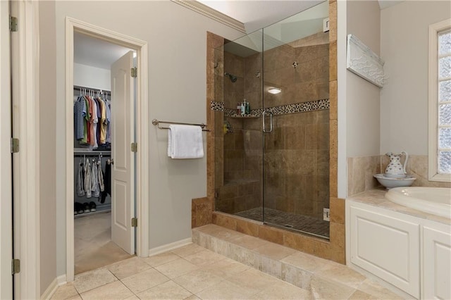 bathroom with tile patterned flooring and separate shower and tub