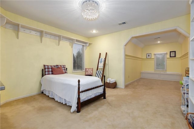 bedroom with a chandelier and carpet