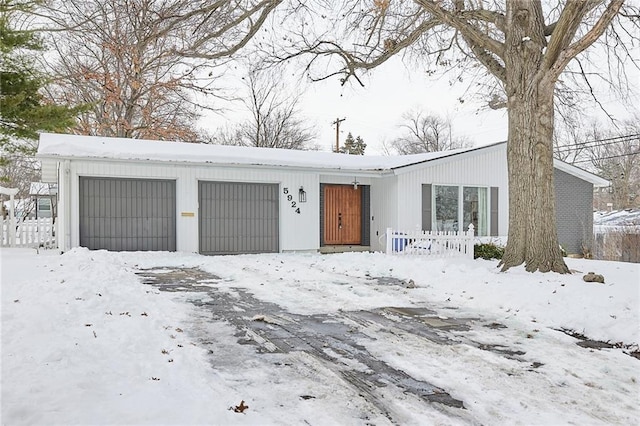 view of front facade featuring a garage and an outbuilding