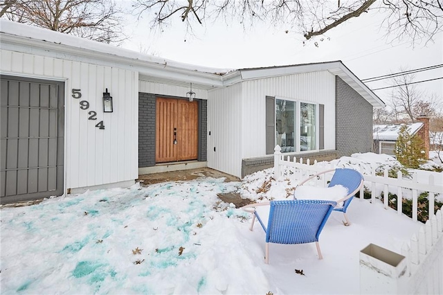 view of snow covered property entrance