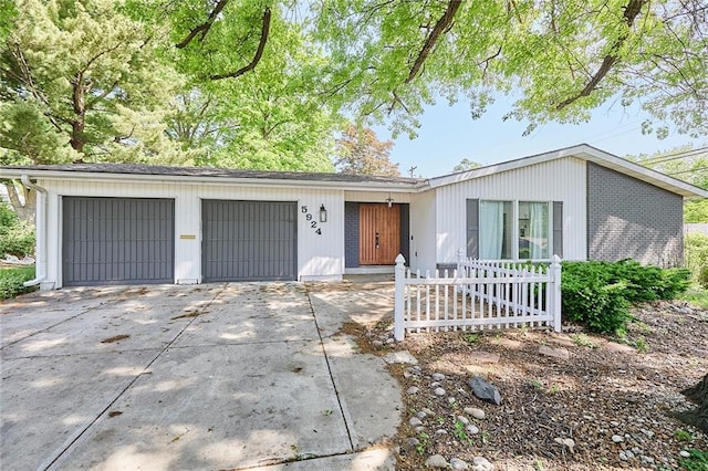 5924 W 87th Ter, Overland Park, KS 66207 - mid-century home featuring an attached garage and driveway