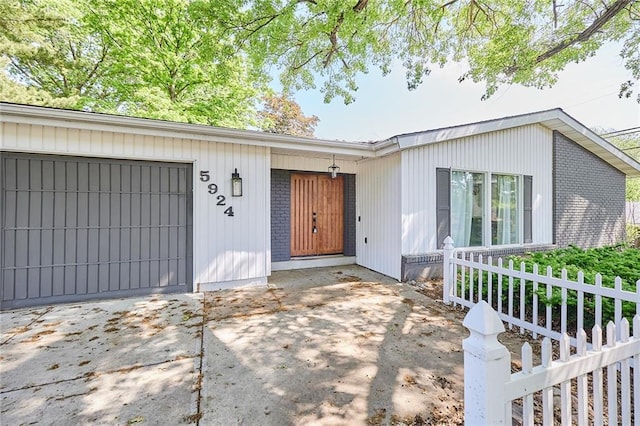 5924 W 87th Ter, Overland Park, KS 66207 - view of front of home with fence, a garage, and brick siding