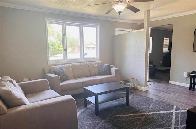 living room featuring a textured ceiling, ceiling fan, crown molding, and dark wood-type flooring