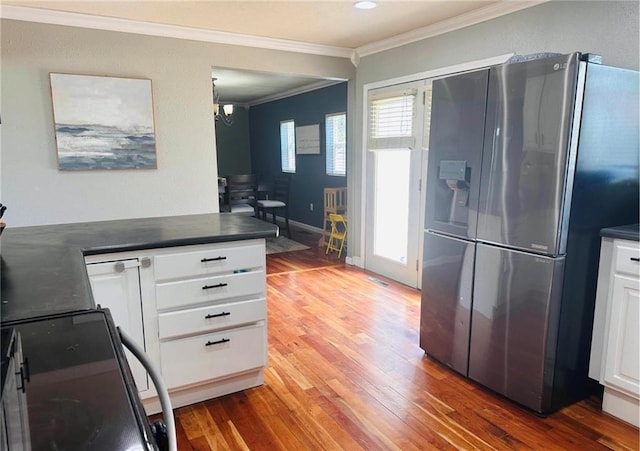 kitchen featuring an inviting chandelier, stainless steel refrigerator with ice dispenser, crown molding, white cabinets, and hardwood / wood-style flooring